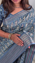 Load and play video in Gallery viewer, Gorgeous Party Wear Muslin Cotton Ajrakh Print Zari Jacquard Border Tussel Work Fancy Designer Saree
